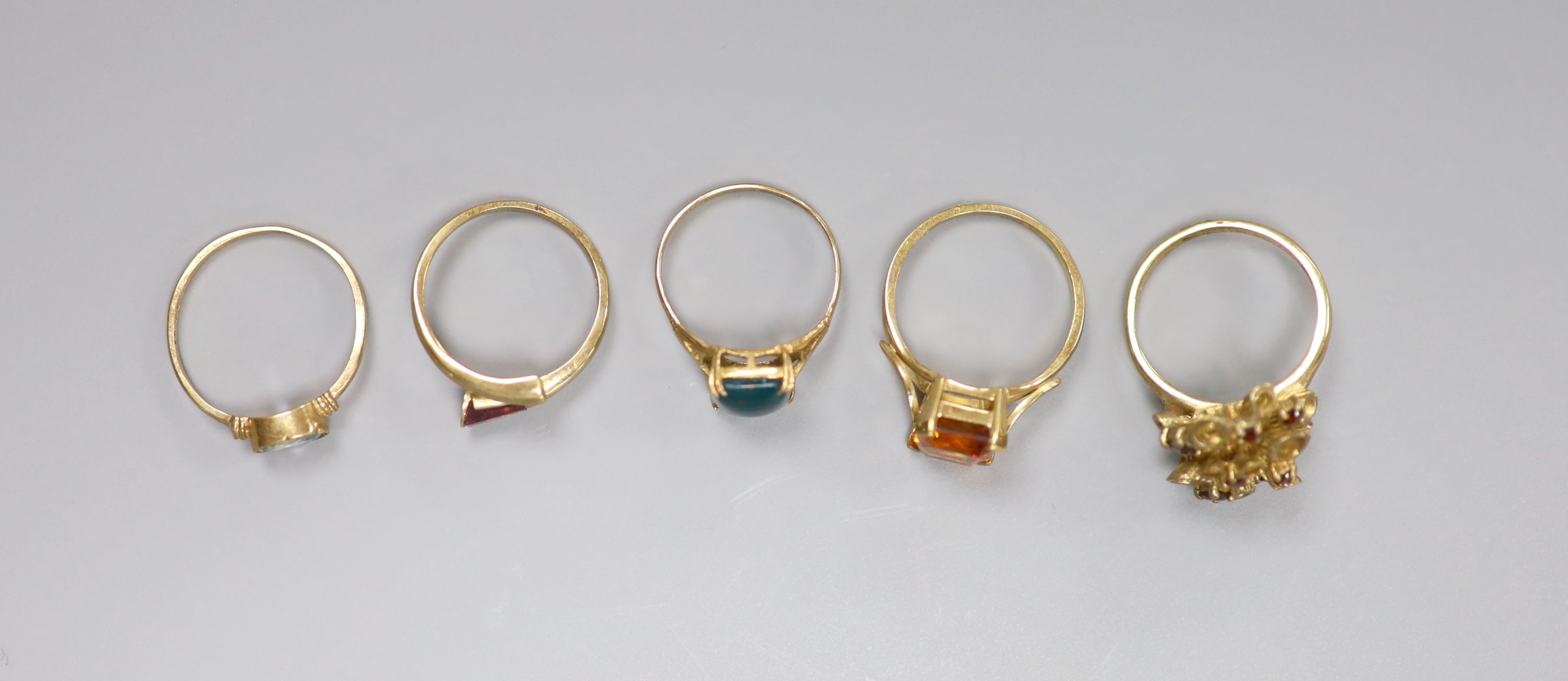 Five assorted modern 9ct gold and gem set dress rings, including bloodstone, garnet and blue zircon